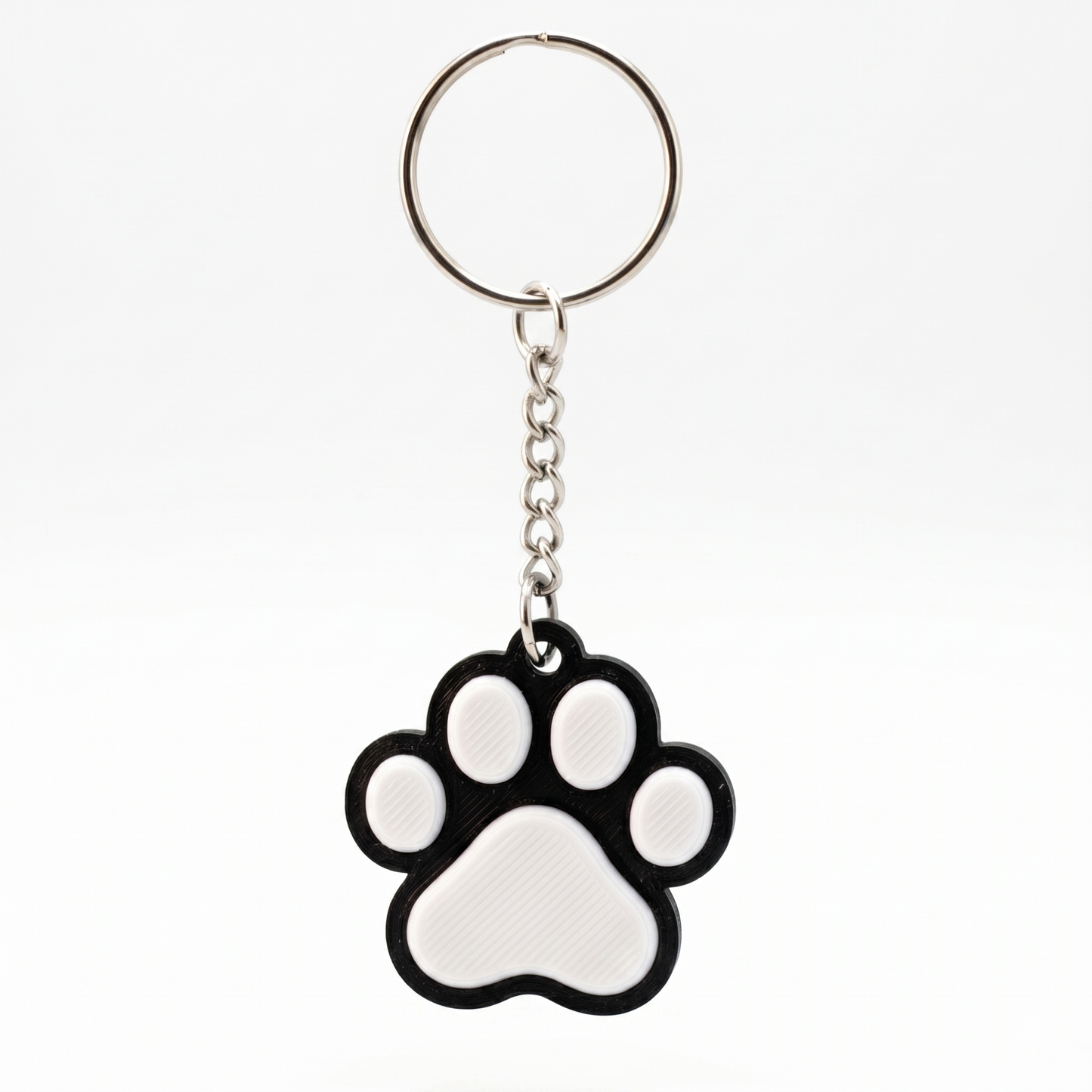 Keychain with a black and white paw print design on a white background