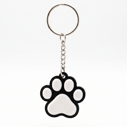Keychain with a black and white paw print design on a white background